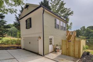 a small house with a garage and a fence at Peaceful Waterfront Studio 16 Mi to Greenville! in Simpsonville