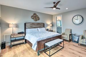 a bedroom with a bed and a clock on the wall at Beautiful Nashville Home near Downtown with Hot Tub! in Nashville