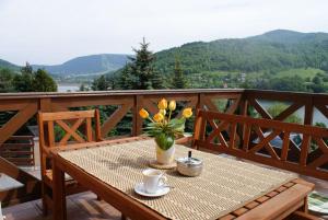 a table with a vase of flowers on a balcony at Villa TRESNA in Tresna +10 photos