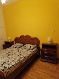 a bedroom with a bed and two night stands at Дом для гостей in Athens