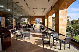 a restaurant with tables and chairs on a patio at Sofitel La Reserva Cardales in Río Luján