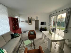 a living room with a couch and a table at Maison avec vue sur le Château in Orléans