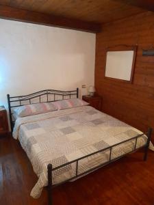 a bedroom with a bed in a room with wooden floors at Ca Angela in Mergozzo