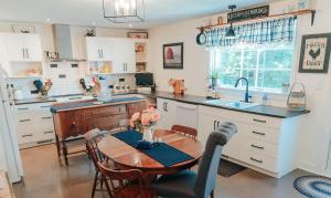 a kitchen with a table and a kitchen with a sink at Clinton Pond Bed and Breakfast in Kensington