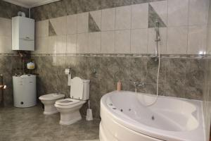 a bathroom with a tub and a toilet and a sink at Apartman NAOMI in Zagreb +20 photos