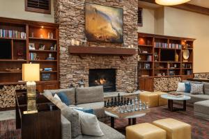 a living room with a fireplace and a stone wall at Sheraton Park City in Park City