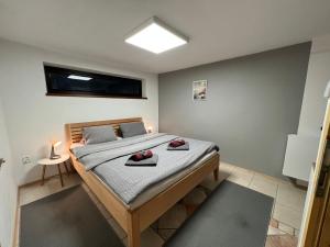 a bedroom with a bed with red shoes on it at Holiday house Lipno-Slupecna in Lipno nad Vltavou