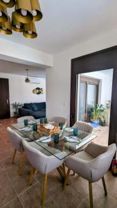 a living room with a glass table and chairs at Casa Christiana, Lardos in Lardos