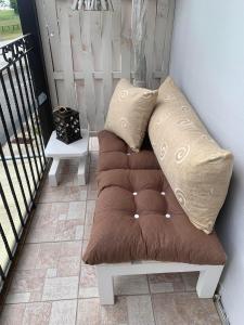 a bench with two pillows on top of a balcony at Mary's apartment in Stomio