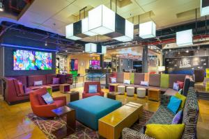 a lobby with colorful chairs and tables in a store at Aloft San Jose Hotel, Costa Rica in San José