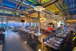 a restaurant with tables and chairs in a room at Aloft San Jose Hotel, Costa Rica in San José