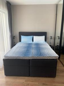 a bedroom with a bed with a blue and white comforter at Open Sea Residence in Byala