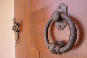 an iron door knocker on a wooden door at New, Premium Finca mit Starlight-Pool! South-East Coast in S'Horta