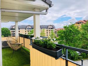 a balcony with several plants on a fence at Cosy Apartement near Geneva in Saint-Julien-en-Genevois