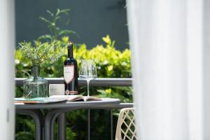 a table with a bottle of wine and a glass at Royal Rei Suite in Umag