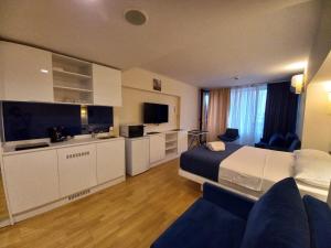 a hotel room with a bed and a kitchen at Batumi OrbiCity apart in Batumi