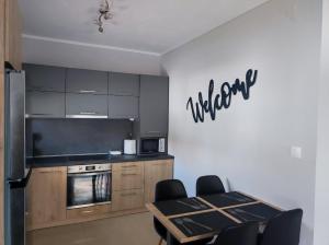 a kitchen with a table and a stove and a refrigerator at A & F Apartments - Ari's house in Kalives Poligirou