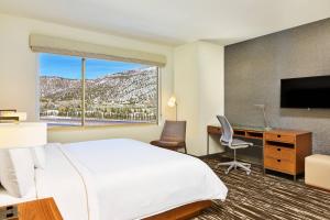 a hotel room with a bed and a desk and a television at Element Basalt - Aspen in Basalt