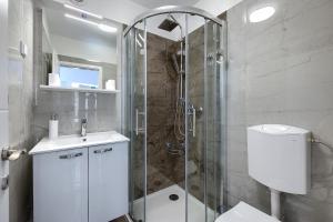 a bathroom with a shower and a toilet and a sink at Studio apartman Luka in Pomer +30 photos