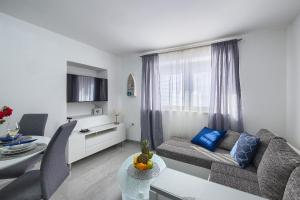 a living room with a couch and a table at Studio apartman Luka in Pomer