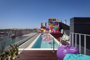 a swimming pool on the roof of a building at Moxy Lisbon City in Lisbon