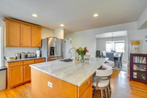 a kitchen with a large island with a counter top at Dog-Friendly Denver Vacation Home with Gas Grill! in Denver
