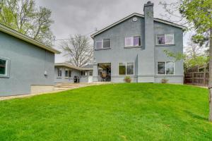a house with a green lawn in front of it at Dog-Friendly Denver Vacation Home with Gas Grill! in Denver