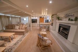 a living room with a couch and a fireplace at CASA MARIA - BEACHFRONT COTTAGE ON THE SAND in Ensenada