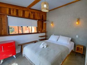 a bedroom with a bed with two white towels on it at Casa Om - Vila de São Jorge in Sao Jorge
