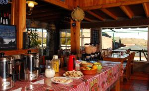 a kitchen with a table with food on it at The Paradise in Puerto Pirámides