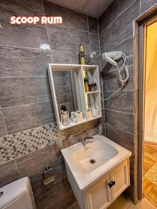 a bathroom with a sink and a mirror at Scoop Rum in Wadi Rum