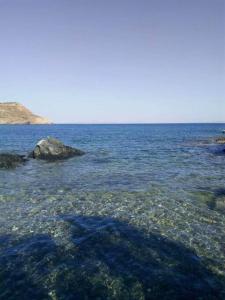 a large body of water with rocks in it at Smaragda home in Liaropá