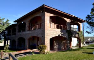 a large brick building with a balcony on it at The Paradise in Puerto Pirámides