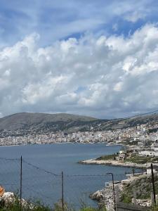 a large body of water with a city in the background at Roel House in Sarandë
