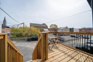 a wooden balcony with a view of a parking lot at The Belvedere:Front Street Flats in Belleville