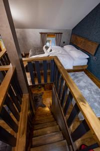 a view of a bedroom with a bed and a staircase at Safir Doğa Evleri in Rize