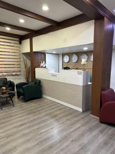 a lobby with a waiting area with chairs and a counter at Hotel Ferah in Araklı