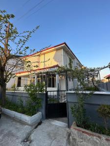 a yellow house with a fence in front of it at Large Beachfront Villa in Natural Seaside with Sea View in Yukarı Kocaali