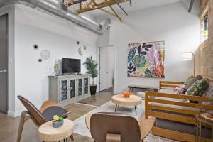 a living room with a couch and a tv at The Cypress Flats in Lafayette