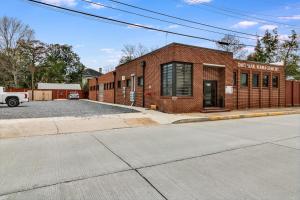 a brick building on the corner of a street at The Cypress Flats in Lafayette