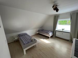a living room with two beds and a window at Mija in Nordenham