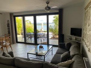a living room with a couch and a glass table at Villa Vilfanova- Apartments in Portorož