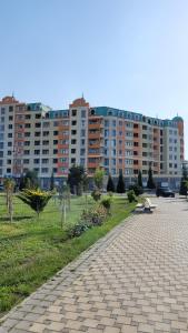 a brick walkway in a park with tall buildings at Sea View House in Sumqayıt