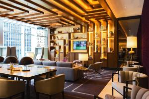 a lobby of a hotel with tables and chairs at Renaissance New York Midtown Hotel in New York