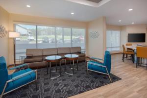 a living room with a couch and a table and chairs at TownePlace Suites by Marriott Niceville Eglin AFB Area in Niceville