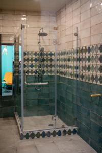 a bathroom with a shower with green tiles at Villa MD Grigoleti in Grigoleti