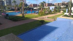 a view of a swimming pool in a resort at Sidi Rahal Blue Beach Appartement Pieds Dans L'eau in Sidi Rahal