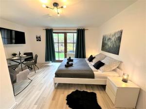 a bedroom with a bed and a living room at COZY Apartment in Bavarian Forest +POOL +SAUNA +NETFLIX in Zwiesel