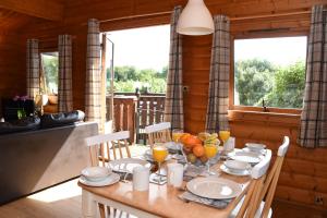 a dining room with a table with fruit on it at Tawny Owl Lodge in Rhayader