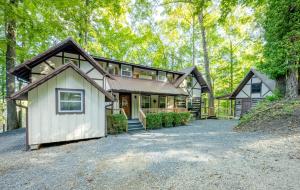 a large house with a garage and a driveway at Chestnut Lodge - Family Cabin on Lake Nantahala in Topton